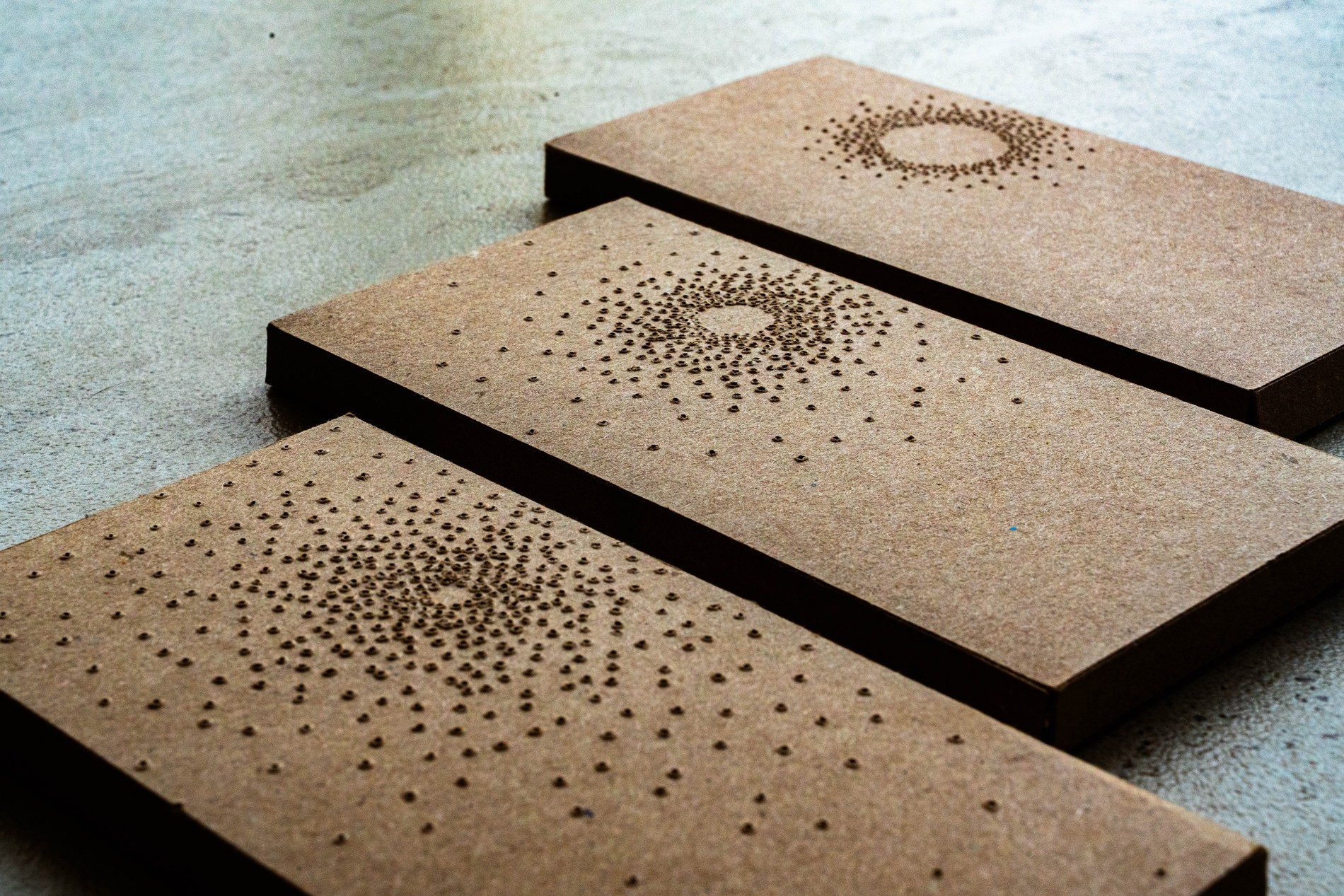 Point of Light packaging, three chocolate boxes arranged diagonally, alternate framing