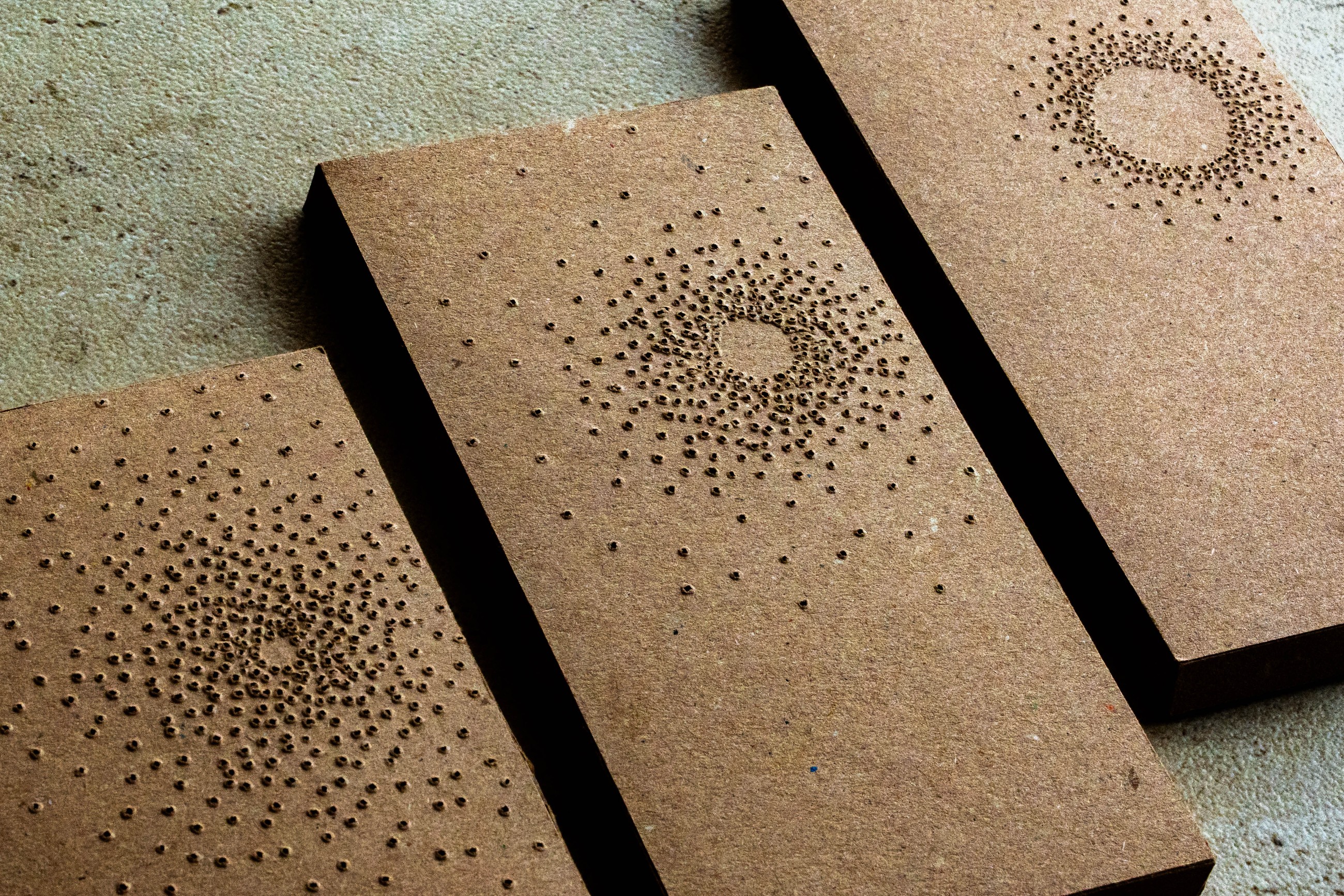 Point of Light packaging, close angled view of the perforated boxes showing the pattern differences up close