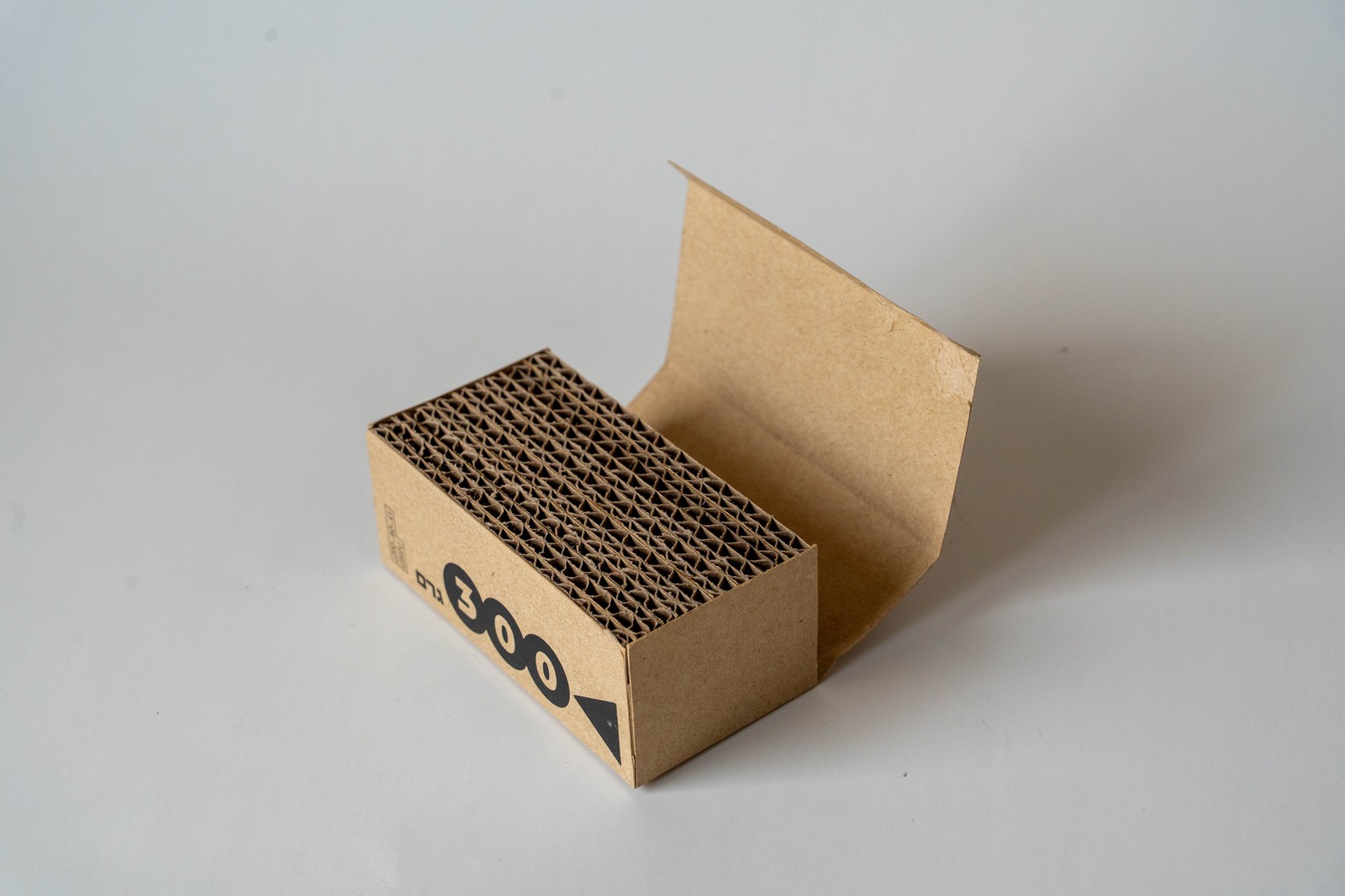 Telem packaging under construction, flap open revealing corrugated interior