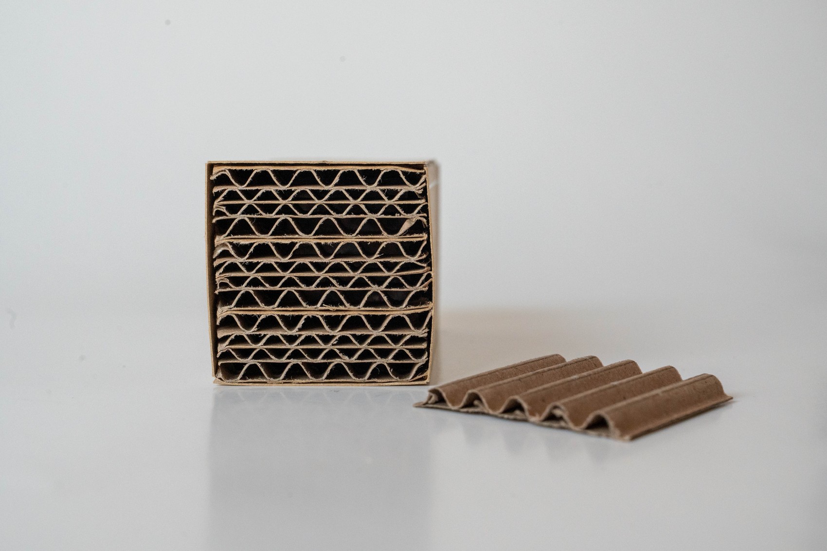 Telem corrugated cardboard cross-section beside an individual sheet
